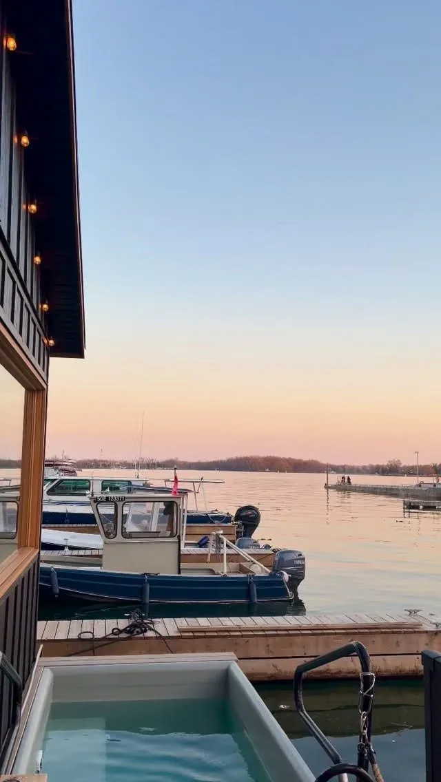 Sunset over the harbour from the sauna deck, boats moored alongside