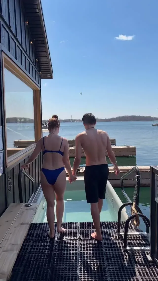 Two guests walking along the deck to the plunge