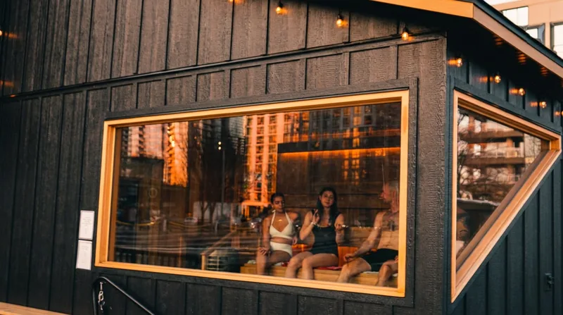 Guests in the sauna window at sunset
