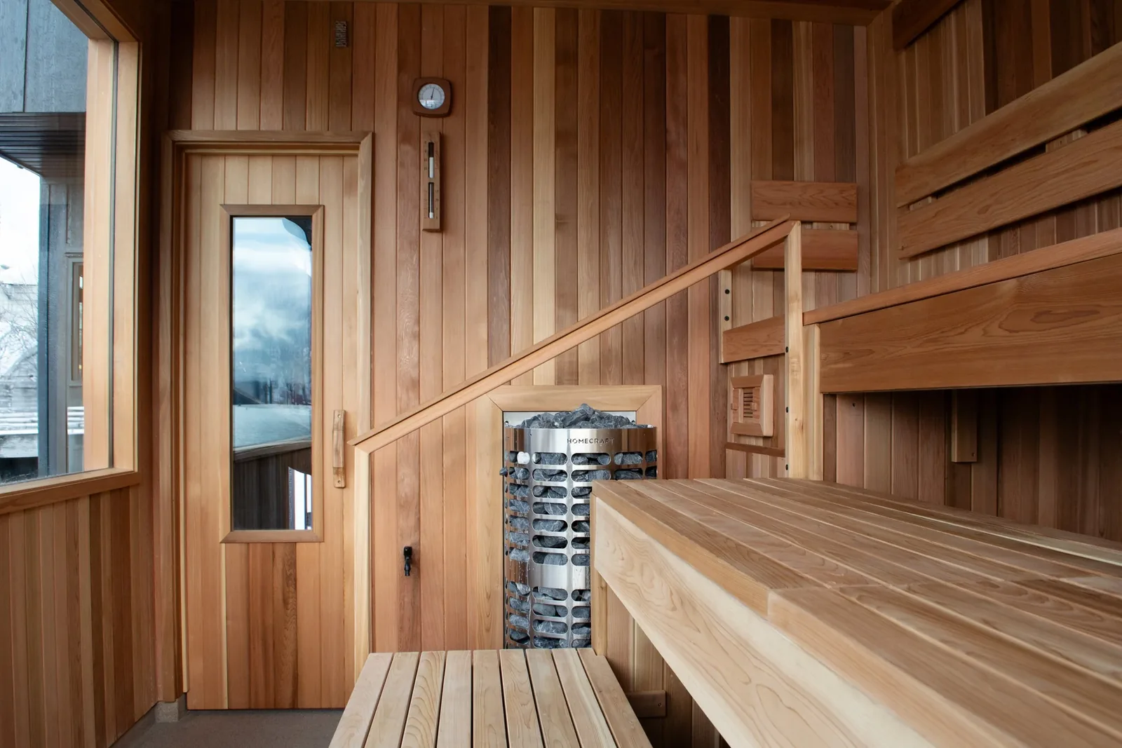 The stove and stones inside the cedar sauna