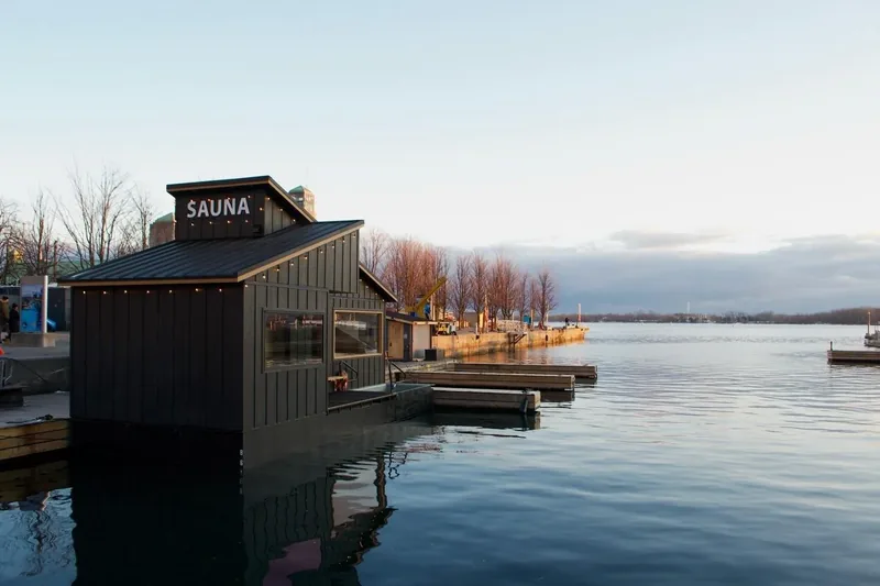 The floating sauna seen from the dock on a still evening